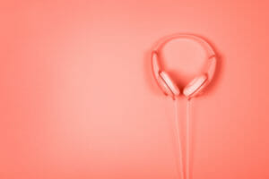 Headphones on coral background