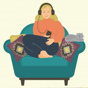 woman in armchair listening to an audiobook