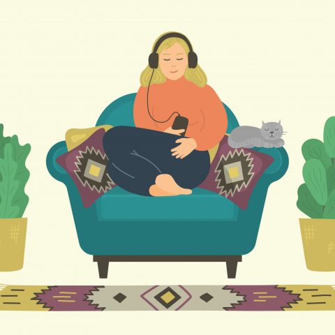 woman in an armchair with a cat and two cactuses